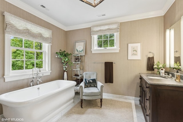 full bath with vanity, a freestanding tub, ornamental molding, tile patterned flooring, and baseboards