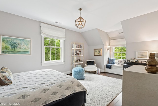 bedroom featuring dark wood-style flooring, lofted ceiling, and baseboards