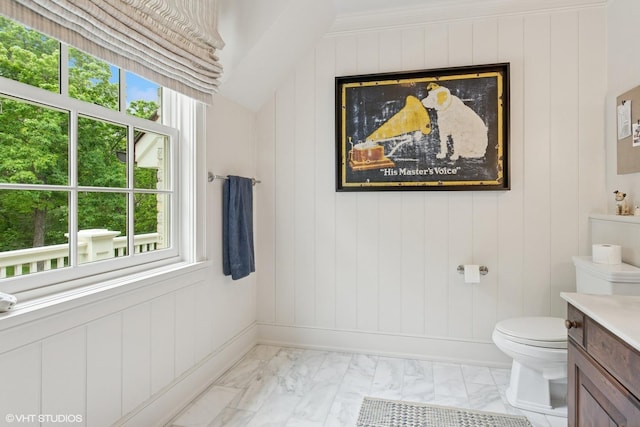 bathroom featuring marble look tiles, vanity, and toilet