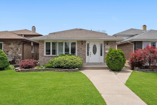 7510 Lorel Ave, Burbank, IL 60459 - bungalow-style house with a front yard, brick siding, and a shingled roof