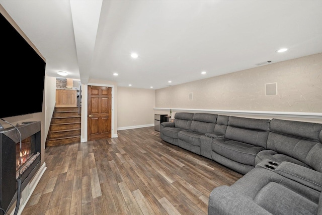 7510 Lorel Ave, Burbank, IL 60459 - living area with wood finished floors, a warm lit fireplace, stairs, and recessed lighting