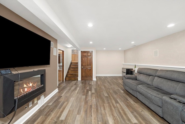 7510 Lorel Ave, Burbank, IL 60459 - living room with a glass covered fireplace, stairway, wood finished floors, and recessed lighting