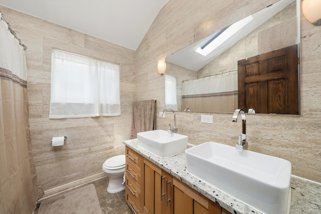 7510 Lorel Ave, Burbank, IL 60459 - bathroom featuring tile walls, vaulted ceiling, a skylight, double vanity, and a shower with curtain