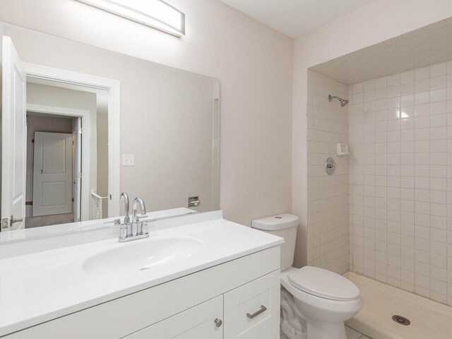 10 Cedar Creek Ct Unit A-10, Palos Heights, IL 60463 - bathroom featuring vanity, tiled shower, and toilet