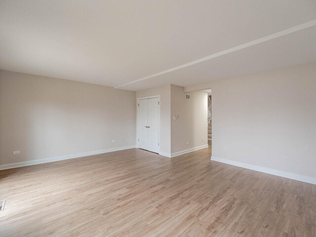 10 Cedar Creek Ct Unit A-10, Palos Heights, IL 60463 - empty room featuring light wood-type flooring, baseboards, and stairway