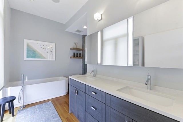 1615 N Wolcott Ave Unit 204, Chicago, IL 60622 - bathroom featuring double vanity, a soaking tub, wood finished floors, and recessed lighting