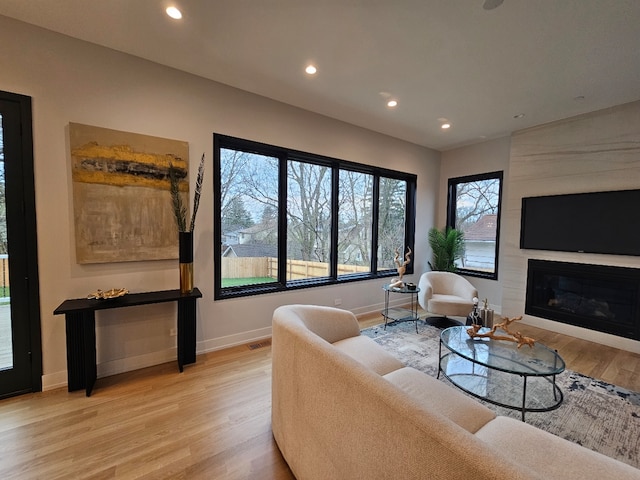 299 Cottage Ave, Glen Ellyn, IL 60137 - living room with light wood-style floors, baseboards, recessed lighting, and a fireplace