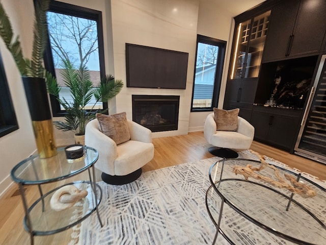 299 Cottage Ave, Glen Ellyn, IL 60137 - living area featuring a glass covered fireplace, light wood-type flooring, and baseboards
