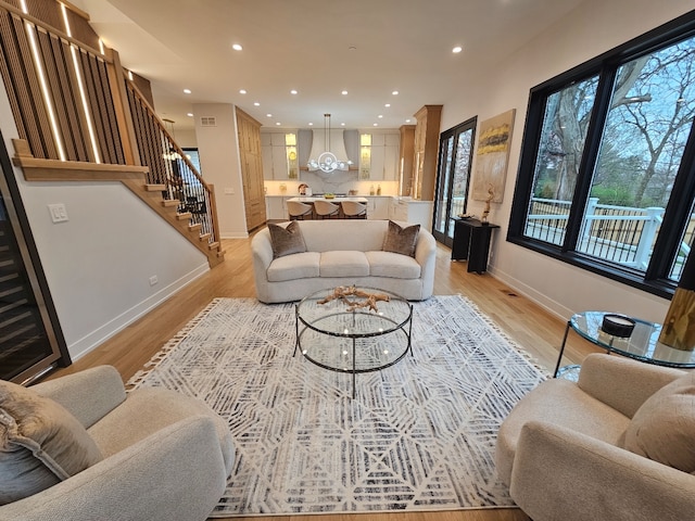 299 Cottage Ave, Glen Ellyn, IL 60137 - living area with recessed lighting, baseboards, light wood-style flooring, stairs, and a chandelier
