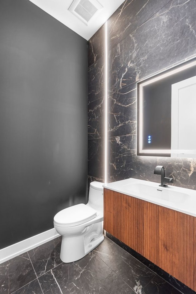 299 Cottage Ave, Glen Ellyn, IL 60137 - bathroom with marble look tiles, vanity, toilet, and baseboards