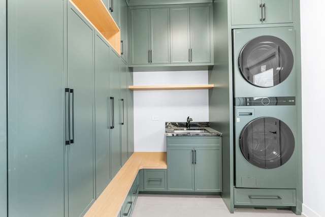 299 Cottage Ave, Glen Ellyn, IL 60137 - washroom featuring stacked washing machine and dryer, cabinet space, and light tile patterned floors