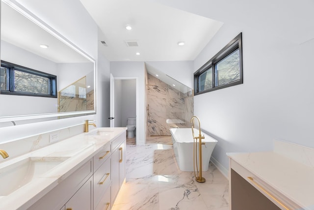 299 Cottage Ave, Glen Ellyn, IL 60137 - full bath featuring a freestanding bath, toilet, double vanity, recessed lighting, and marble tiled flooring