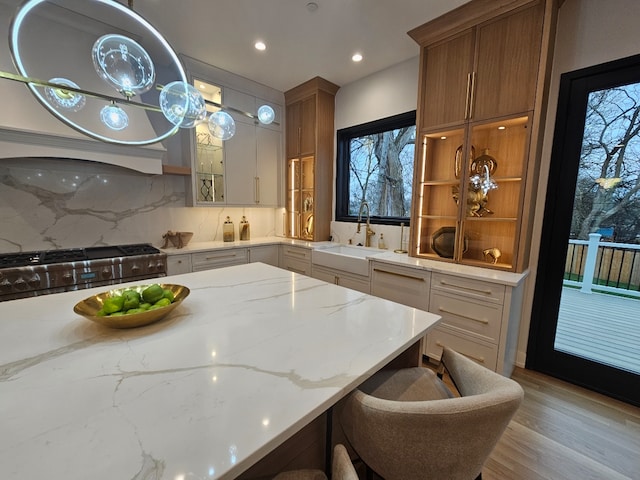 299 Cottage Ave, Glen Ellyn, IL 60137 - kitchen featuring a sink, decorative backsplash, light stone counters, stainless steel gas range oven, and recessed lighting