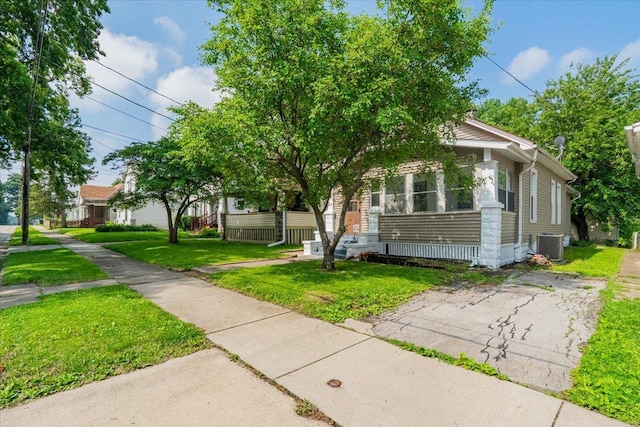 810 N Oak St, Bloomington, IL 61701 - obstructed view of property featuring central air condition unit and a front yard