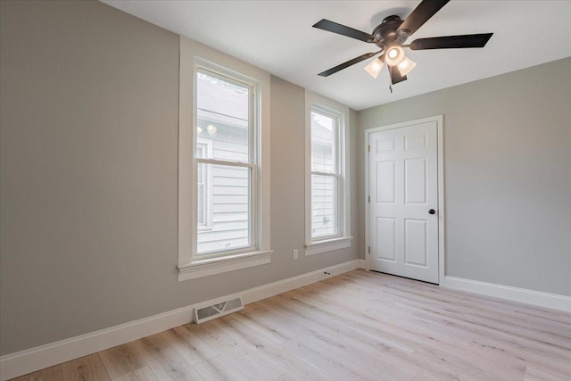 810 N Oak St, Bloomington, IL 61701 - unfurnished room featuring light wood-type flooring, healthy amount of natural light, and baseboards