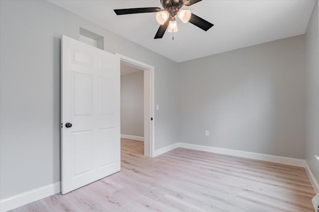 810 N Oak St, Bloomington, IL 61701 - spare room with light wood finished floors, a ceiling fan, and baseboards