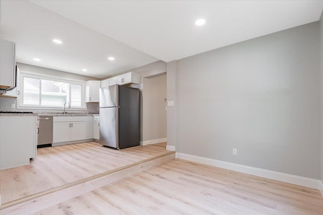 810 N Oak St, Bloomington, IL 61701 - kitchen with stainless steel appliances, light wood finished floors, baseboards, white cabinets, and recessed lighting