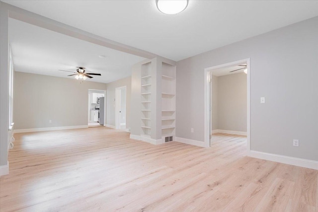810 N Oak St, Bloomington, IL 61701 - spare room featuring built in features, ceiling fan, light wood-type flooring, and baseboards