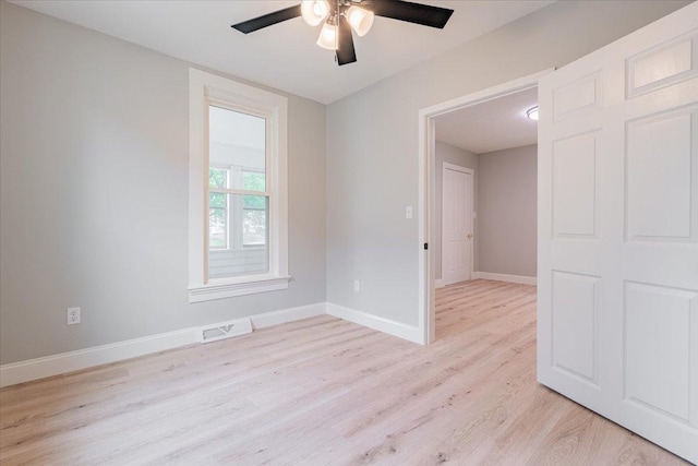 810 N Oak St, Bloomington, IL 61701 - spare room with ceiling fan, light wood-type flooring, and baseboards