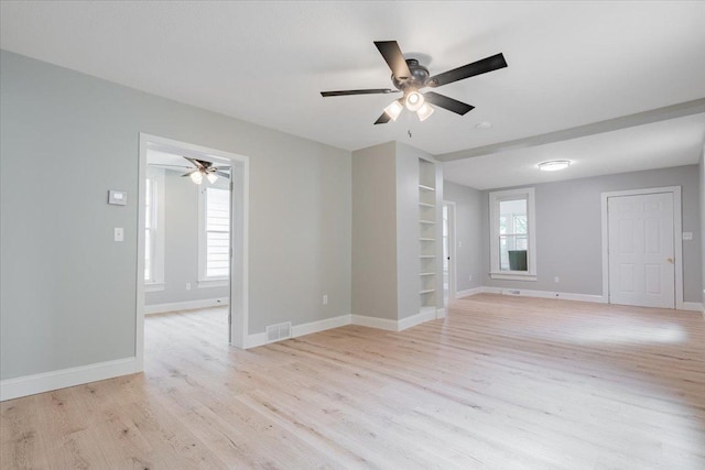 810 N Oak St, Bloomington, IL 61701 - empty room with a ceiling fan, built in features, light wood-style flooring, and baseboards