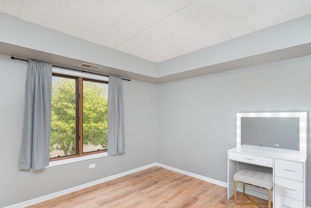 1068 Ashley Ct N Unit 2A, Lockport, IL 60441 - unfurnished room with wood finished floors, a textured ceiling, and baseboards