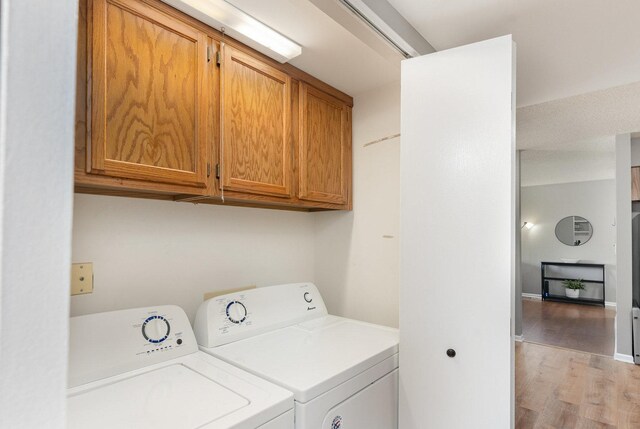 1068 Ashley Ct N Unit 2A, Lockport, IL 60441 - laundry area with cabinet space, independent washer and dryer, and light wood-style flooring