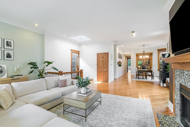 706 W Melrose Ave Unit 3, Chicago, IL 60657 - living room featuring a fireplace, recessed lighting, light wood-type flooring, a chandelier, and a skylight