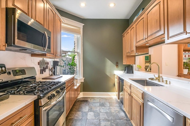 706 W Melrose Ave Unit 3, Chicago, IL 60657 - kitchen with stainless steel appliances, baseboards, a sink, recessed lighting, and dark stone finish flooring
