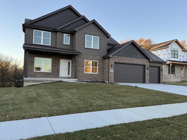 15937 Orchid Ln, Lockport, IL 60441 - view of front of home with board and batten siding, an attached garage, and brick siding