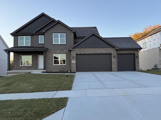 15937 Orchid Ln, Lockport, IL 60441 - view of front facade featuring an attached garage, driveway, a front yard, brick siding, and board and batten siding