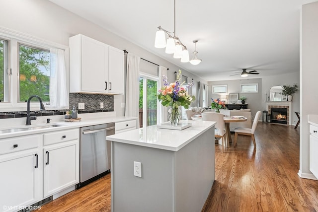 0N611 W Weaver Cir, Geneva, IL 60134 - kitchen featuring stainless steel dishwasher, a sink, ceiling fan, light wood finished floors, and a kitchen island