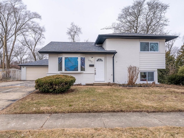 640 Enterprise Rd, Chicago Heights, IL 60411 - tri-level home featuring a garage, brick siding, concrete driveway, and a shingled roof