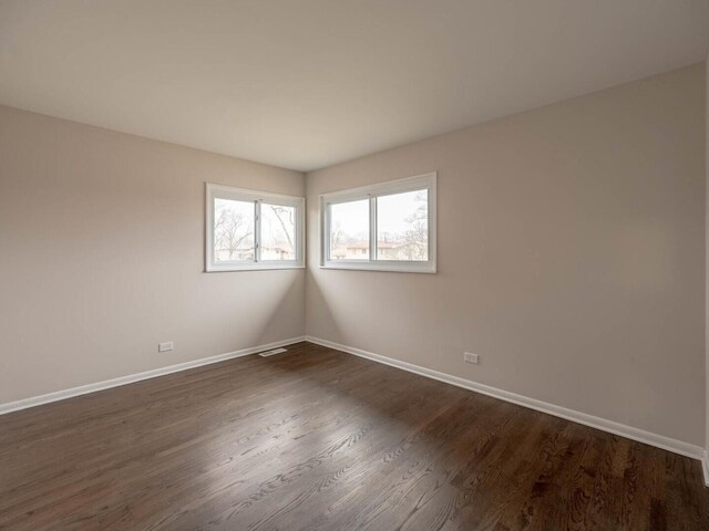 640 Enterprise Rd, Chicago Heights, IL 60411 - spare room featuring baseboards and dark wood-type flooring
