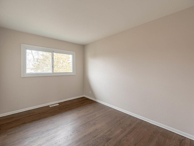 640 Enterprise Rd, Chicago Heights, IL 60411 - spare room featuring dark wood-style flooring and baseboards