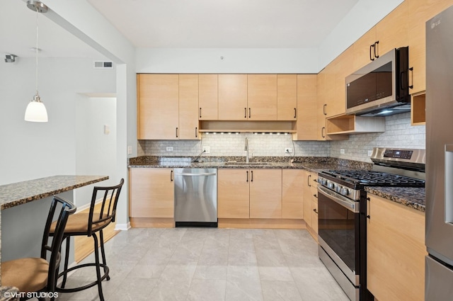 911 Busse Hwy Unit 302, Park Ridge, IL 60068 - kitchen featuring appliances with stainless steel finishes, light brown cabinets, a sink, dark stone counters, and tasteful backsplash