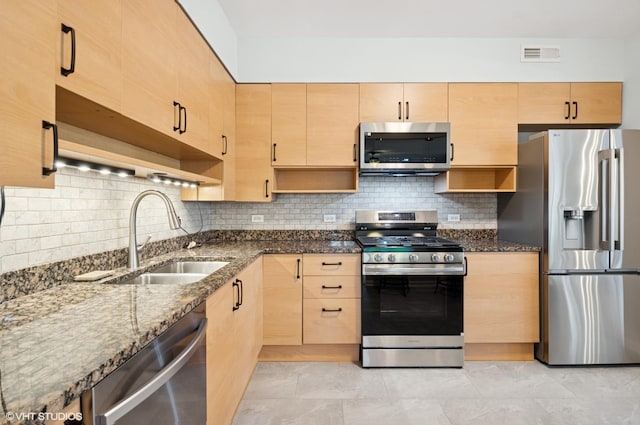 911 Busse Hwy Unit 302, Park Ridge, IL 60068 - kitchen featuring stainless steel appliances, light brown cabinetry, a sink, dark stone countertops, and tasteful backsplash