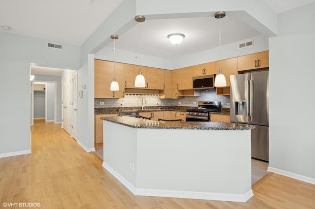 911 Busse Hwy Unit 302, Park Ridge, IL 60068 - kitchen with appliances with stainless steel finishes, tasteful backsplash, light wood-type flooring, dark stone counters, and hanging light fixtures