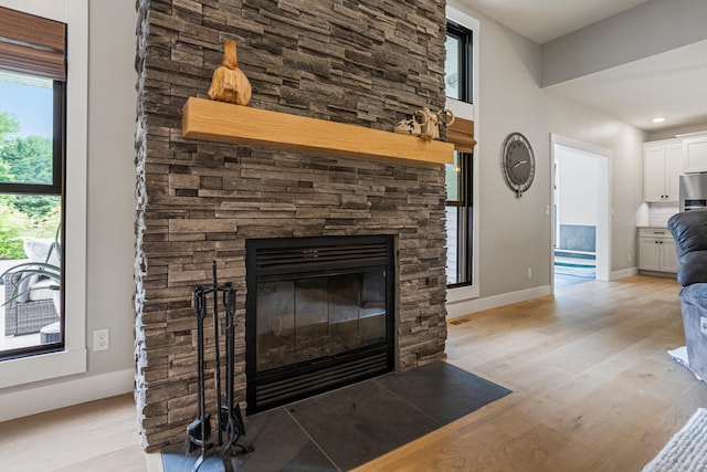 4203 Curtis Meadow Dr, Champaign, IL 61822 - living room with light wood-style flooring and a stone fireplace