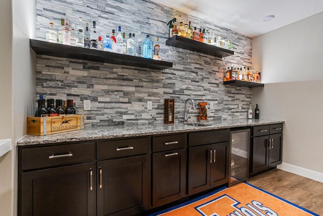 4203 Curtis Meadow Dr, Champaign, IL 61822 - indoor wet bar with wine cooler, tasteful backsplash, and light wood-style floors
