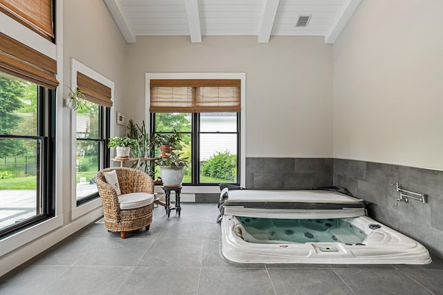 4203 Curtis Meadow Dr, Champaign, IL 61822 - bathroom featuring a jetted tub, beam ceiling, tile patterned flooring, and tile walls