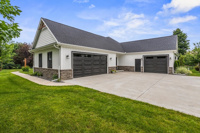 4203 Curtis Meadow Dr, Champaign, IL 61822 - modern farmhouse with stone siding, driveway, a garage, and a front yard