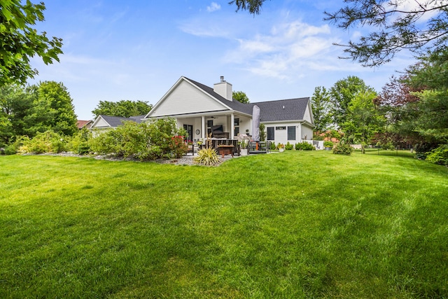 4203 Curtis Meadow Dr, Champaign, IL 61822 - rear view of house with a lawn, a chimney, a ceiling fan, and a patio