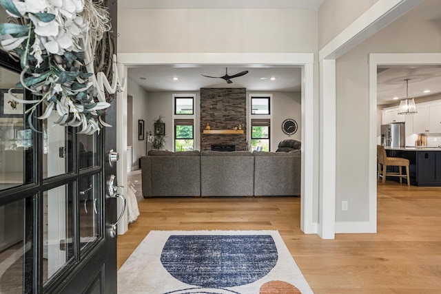 4203 Curtis Meadow Dr, Champaign, IL 61822 - entryway with light wood-style floors, a ceiling fan, a fireplace, and recessed lighting