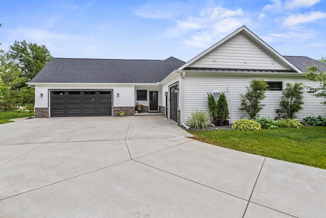 4203 Curtis Meadow Dr, Champaign, IL 61822 - view of front of house featuring driveway, a garage, stone siding, and a front lawn