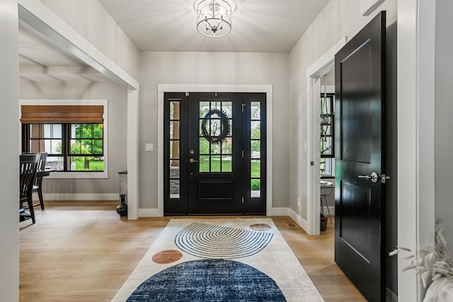 4203 Curtis Meadow Dr, Champaign, IL 61822 - foyer entrance featuring light wood-style flooring, plenty of natural light, and a chandelier