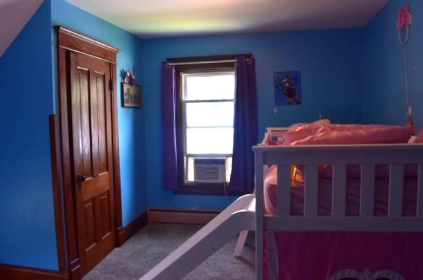 1207 4th Ave, Sterling, IL 61081 - carpeted bedroom with baseboard heating, cooling unit, and baseboards