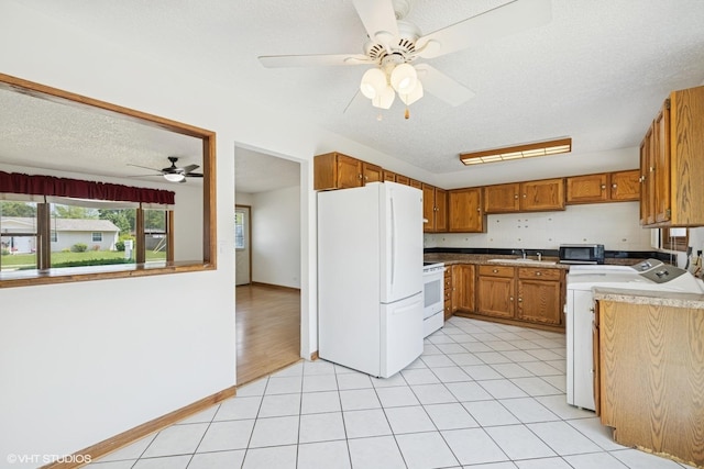 325 Larkdale Row, Wauconda, IL 60084 - kitchen featuring white appliances, ceiling fan, brown cabinetry, a textured ceiling, and light countertops