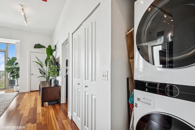 230 W Division St Unit 1208, Chicago, IL 60610 - laundry area with estacked washer and dryer, track lighting, wood finished floors, and baseboards