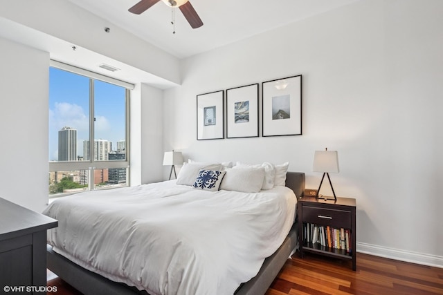 230 W Division St Unit 1208, Chicago, IL 60610 - bedroom with wood finished floors, multiple windows, baseboards, and a ceiling fan