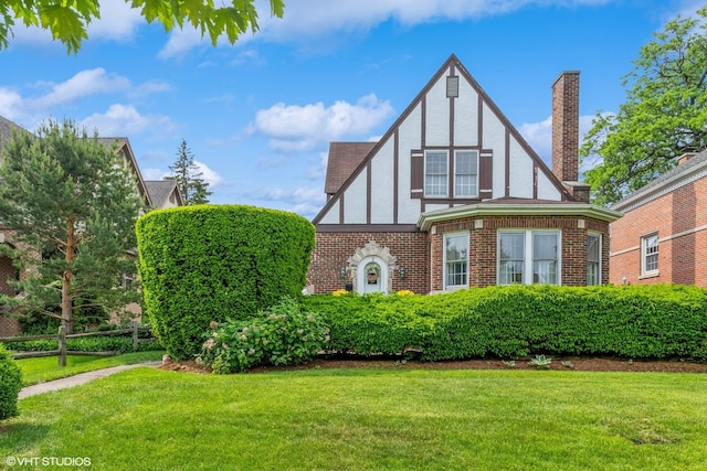 239 Imperial St, Park Ridge, IL 60068 - view of front of home featuring stucco siding, a front lawn, a chimney, and brick siding